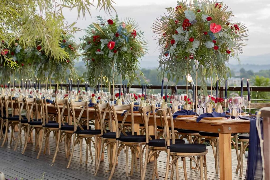Wedding reception tables with tall floral arrangements