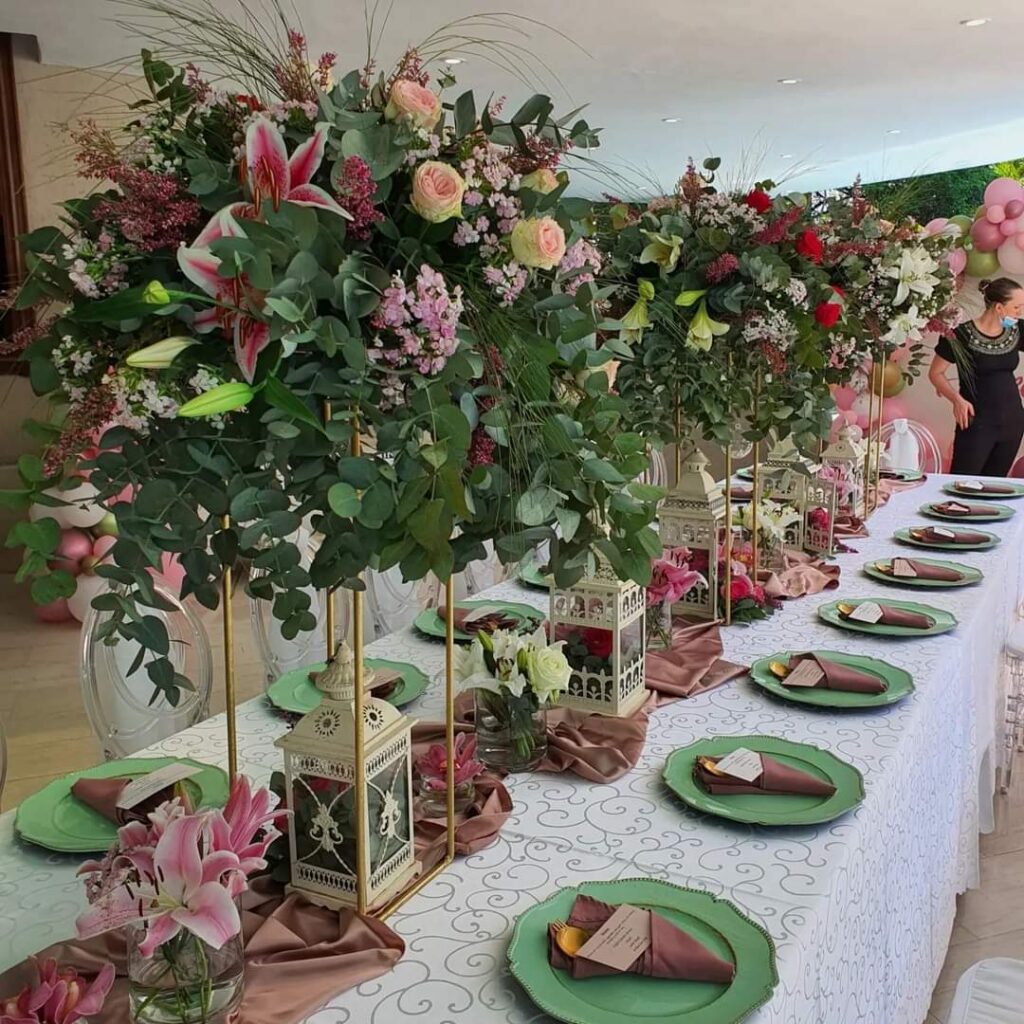 Wedding reception table with pink flowers and greenery
