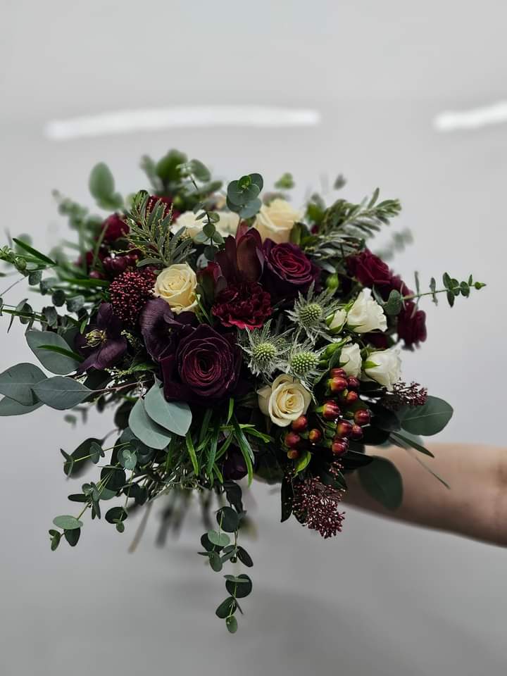 Burgundy rose bridal bouquet with greenery
