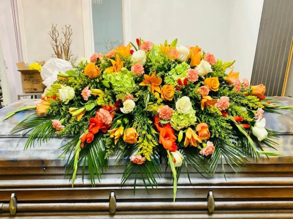 Orange and green mixed casket spray