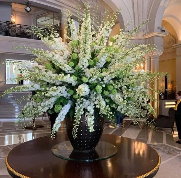 Large white arrangement in a black vase