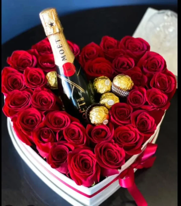 Heart-shaped box of red roses with mini champagne and chocolates